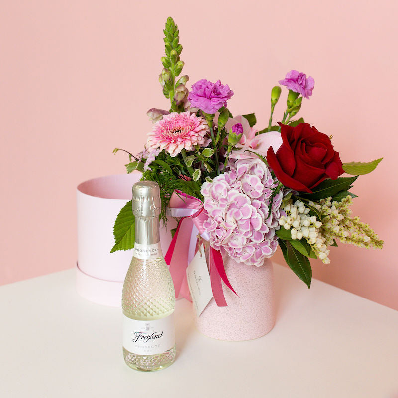 send flowers to your bestie with a petite seasonal flowers and a bottle of bubbly
