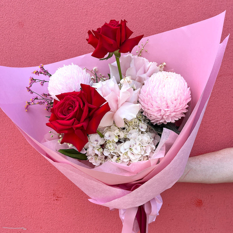 red and pink flower bouquet with roses